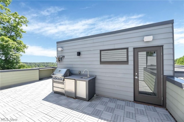 view of patio / terrace with a grill, exterior kitchen, and sink