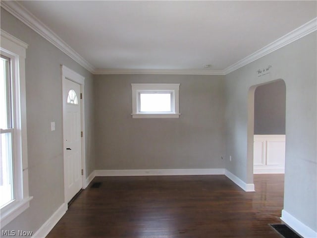 interior space with dark hardwood / wood-style floors and ornamental molding