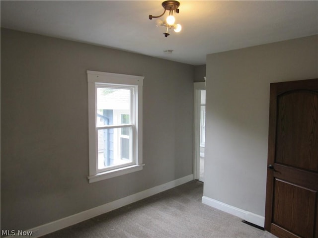 empty room featuring light carpet