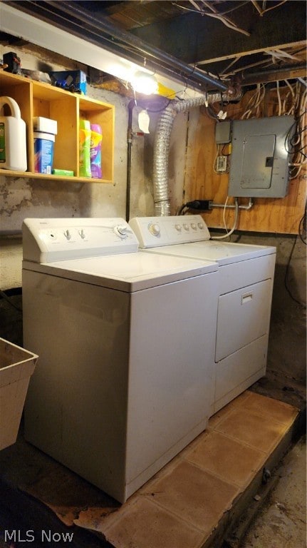 washroom featuring sink, washer and dryer, and electric panel