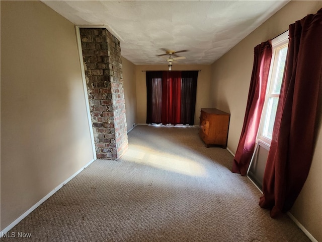 hall with plenty of natural light and light colored carpet