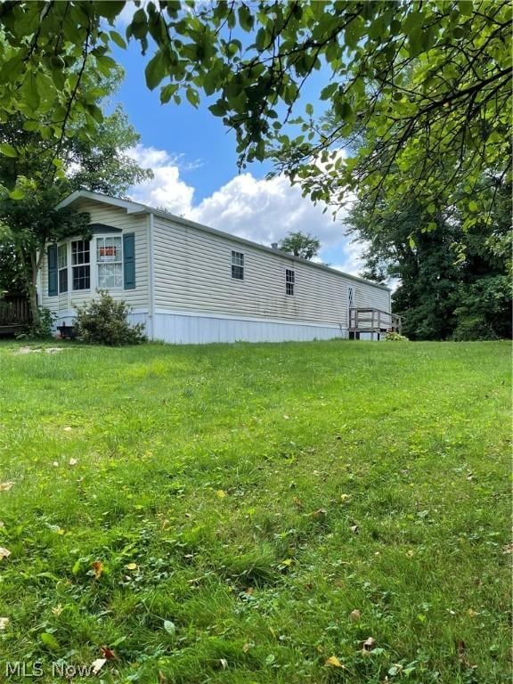 view of property exterior with a yard