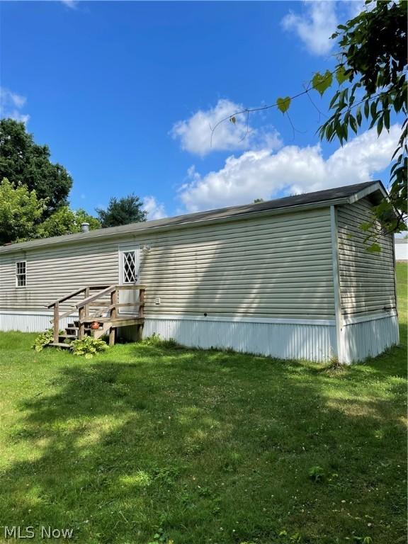 view of property exterior featuring a lawn