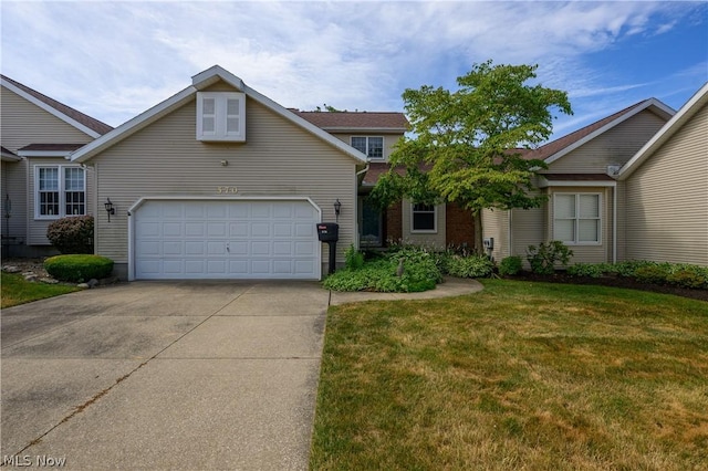 view of front of house with a front yard and a garage