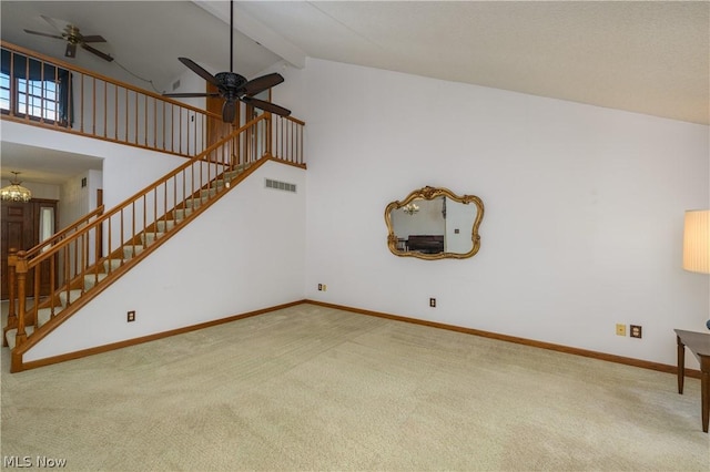 carpeted living room featuring beamed ceiling, ceiling fan with notable chandelier, and high vaulted ceiling