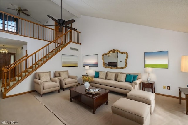 living room with beam ceiling, high vaulted ceiling, light colored carpet, and ceiling fan with notable chandelier