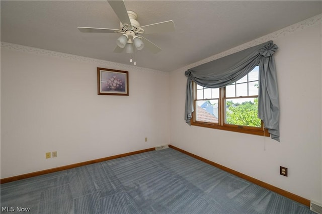 carpeted empty room featuring ceiling fan