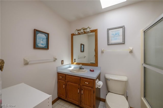 full bathroom with a skylight, tile patterned floors, vanity, enclosed tub / shower combo, and toilet