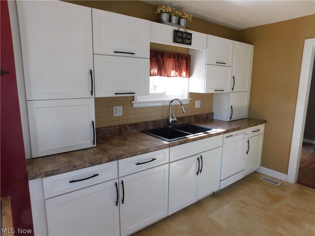 kitchen featuring sink, white cabinets, and dishwasher