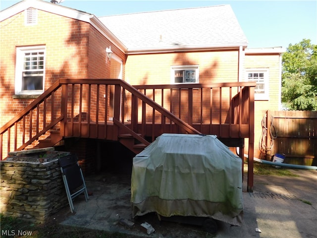 rear view of house featuring a wooden deck