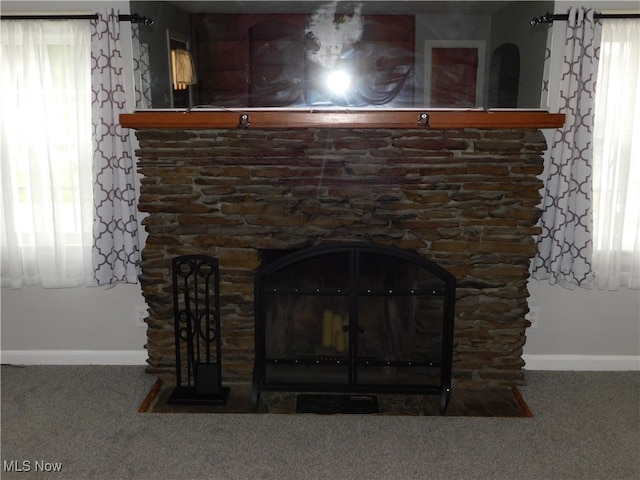 interior details with a fireplace and carpet floors