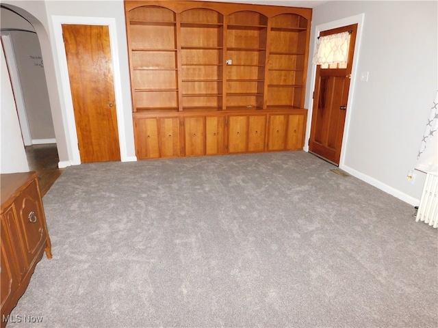 interior space featuring dark colored carpet