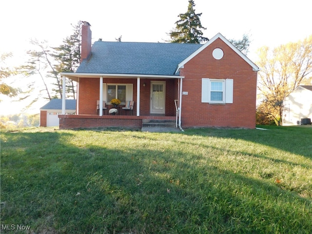 view of front of property featuring a porch, a front yard, and a garage