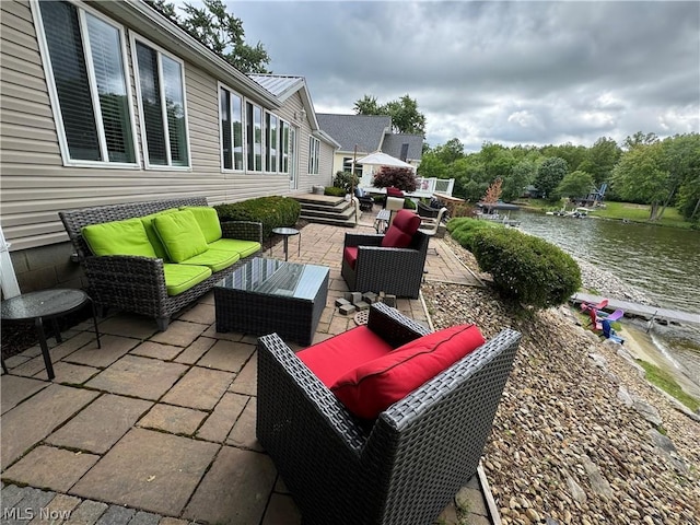 view of patio featuring outdoor lounge area and a water view