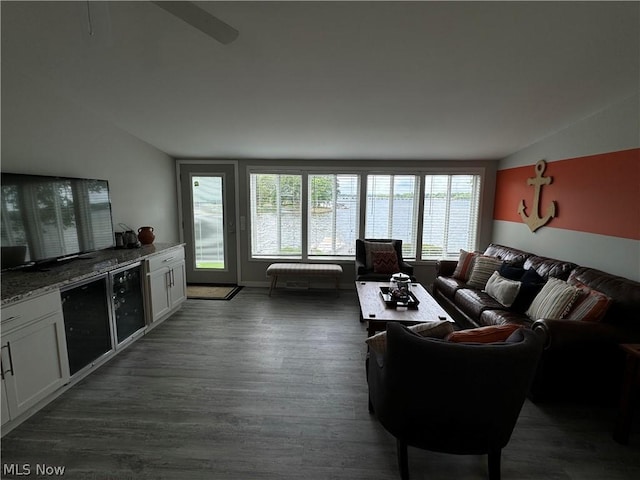 living room featuring dark hardwood / wood-style flooring and vaulted ceiling