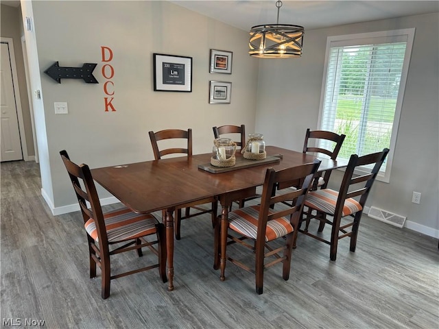 dining area with a notable chandelier and wood-type flooring