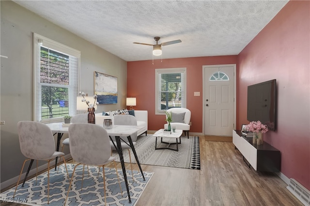 interior space with hardwood / wood-style flooring, ceiling fan, and a textured ceiling