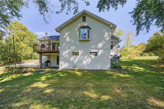 back of house with a yard and a deck