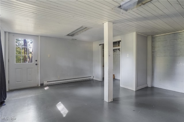 garage featuring wooden ceiling and baseboard heating