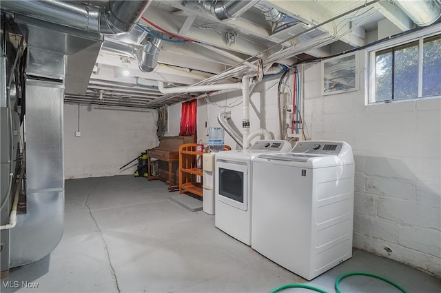 basement with heating unit and washing machine and clothes dryer