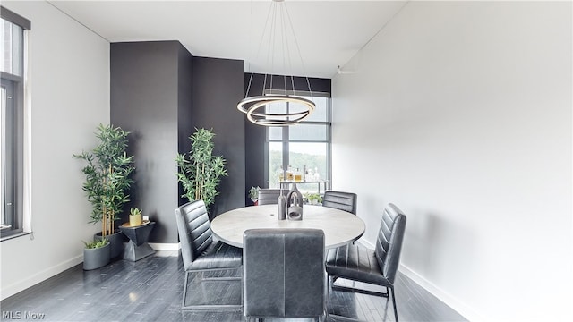 dining area featuring dark hardwood / wood-style floors and a chandelier