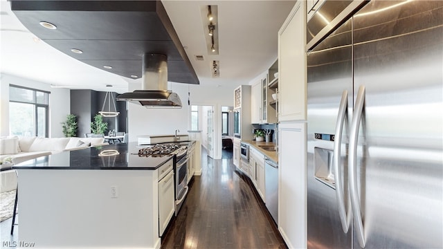 kitchen with a center island, dark wood-type flooring, stainless steel appliances, island exhaust hood, and white cabinets