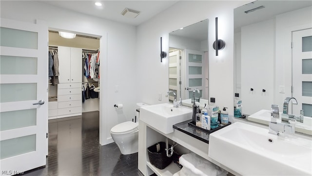 bathroom with vanity, wood-type flooring, and toilet