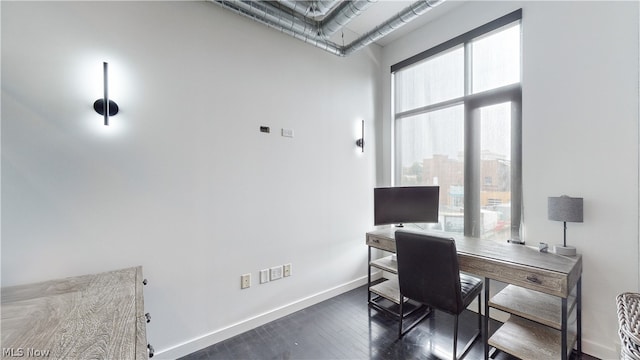 office space with dark wood-type flooring