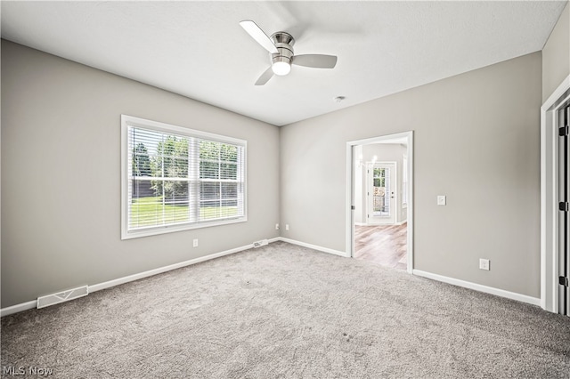 carpeted empty room featuring ceiling fan