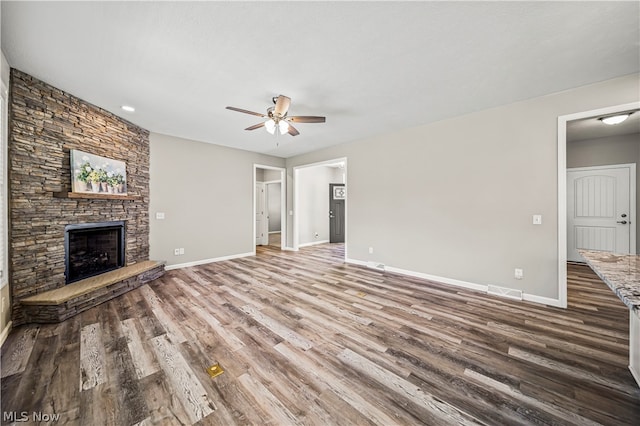 unfurnished living room with a fireplace, ceiling fan, and hardwood / wood-style floors