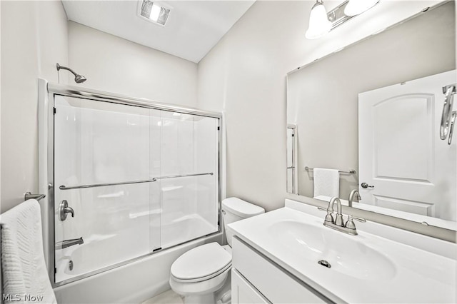 full bath with visible vents, combined bath / shower with glass door, vanity, and toilet