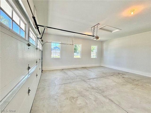 garage with baseboards and a garage door opener