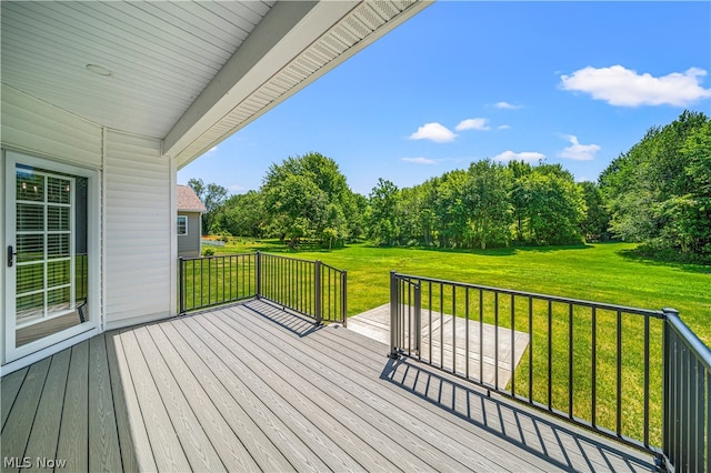 wooden terrace with a lawn