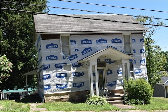 view of front of home featuring roof with shingles