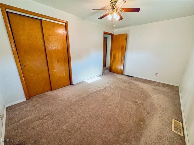 304 Stone Rd, Belpre, OH 45714 - unfurnished bedroom featuring light carpet, a closet, and ceiling fan