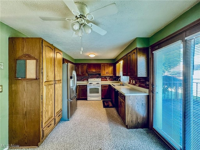 304 Stone Rd, Belpre, OH 45714 - kitchen with electric stove, stainless steel fridge, sink, and a textured ceiling