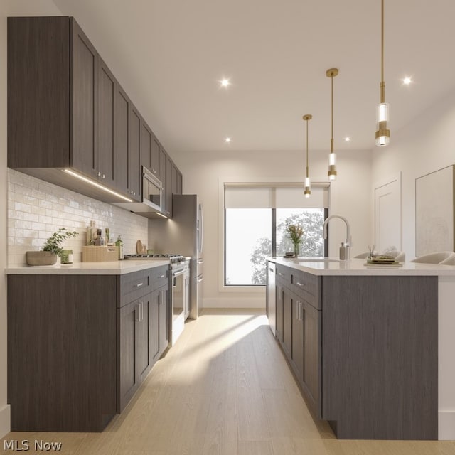 kitchen featuring light hardwood / wood-style flooring, backsplash, stainless steel appliances, decorative light fixtures, and dark brown cabinetry