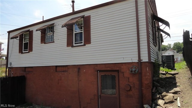 view of side of property with central AC