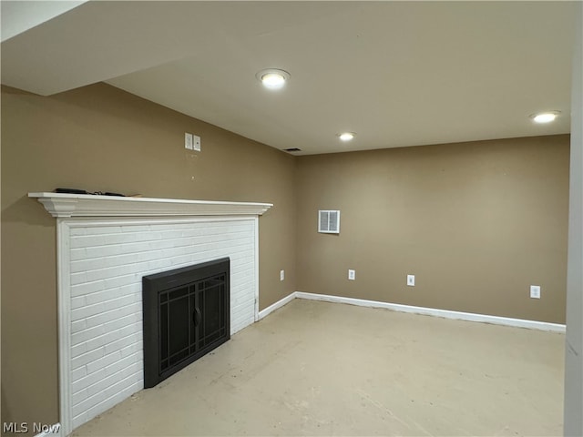 unfurnished living room with a brick fireplace