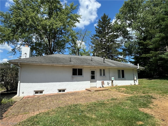 rear view of property featuring a yard