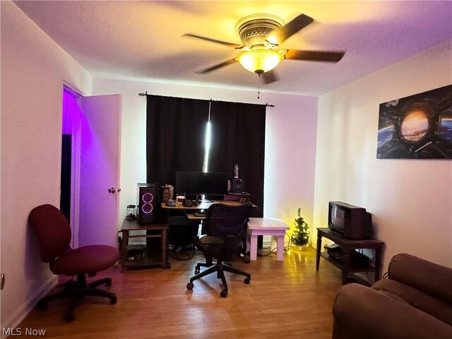 office space with wood-type flooring and ceiling fan