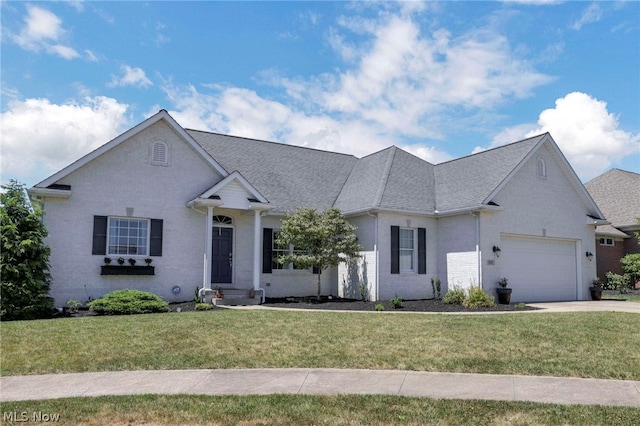 view of front of home featuring a garage and a front lawn