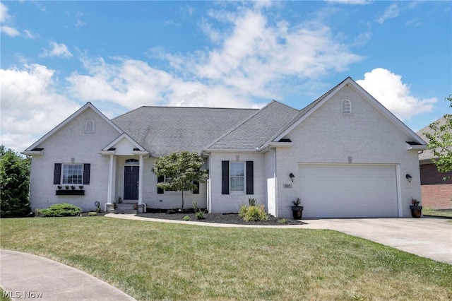 ranch-style house featuring a front yard and a garage