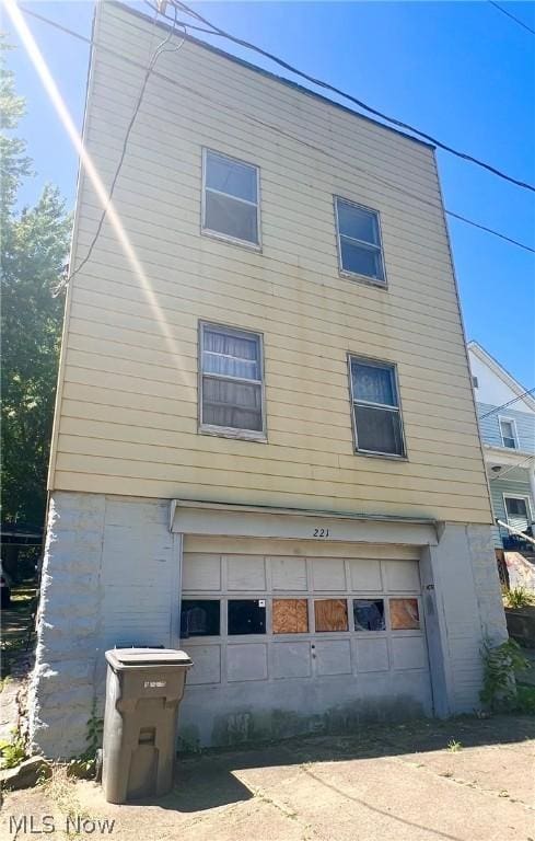 back of property featuring a garage