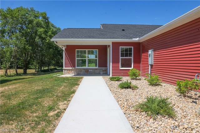 view of exterior entry featuring a yard