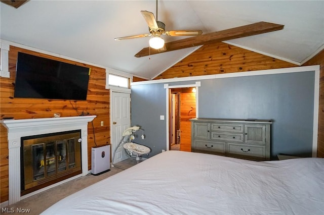 bedroom with ceiling fan, vaulted ceiling, light carpet, and wood walls