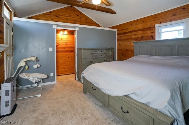 carpeted bedroom featuring ceiling fan, wood walls, and lofted ceiling with beams