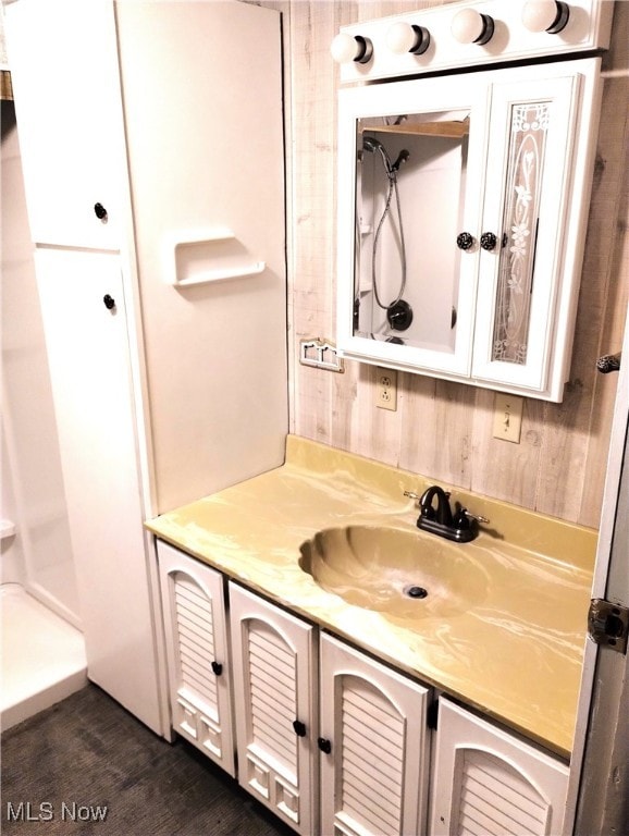 bathroom with vanity and a shower