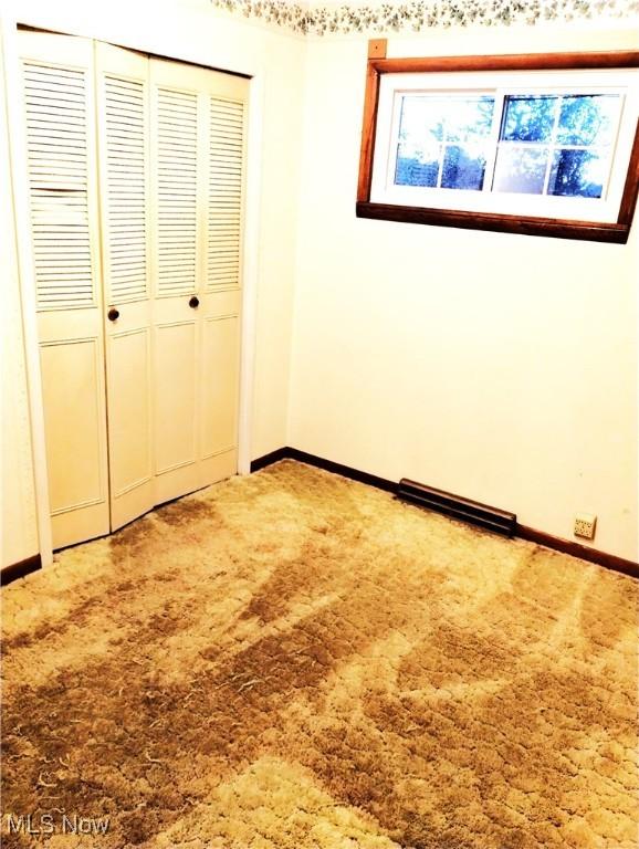 54885 Mount Victory Rd, Powhatan Point, OH 43942 - unfurnished bedroom featuring a closet, carpet flooring, and baseboards