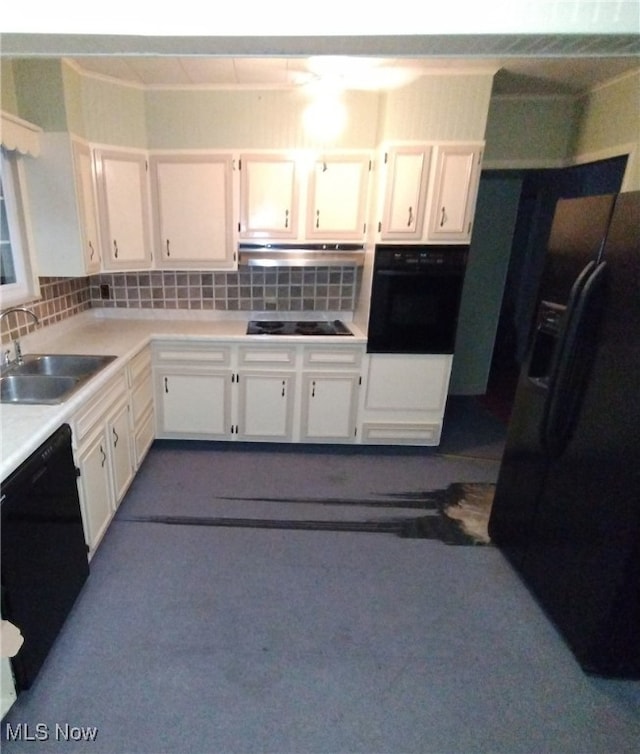 kitchen featuring white cabinets, sink, tasteful backsplash, and black appliances